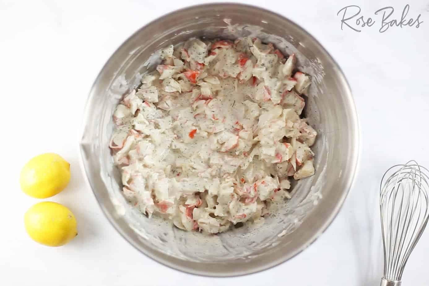 mixing Creamy dressing with crab meat in a silver bowl 