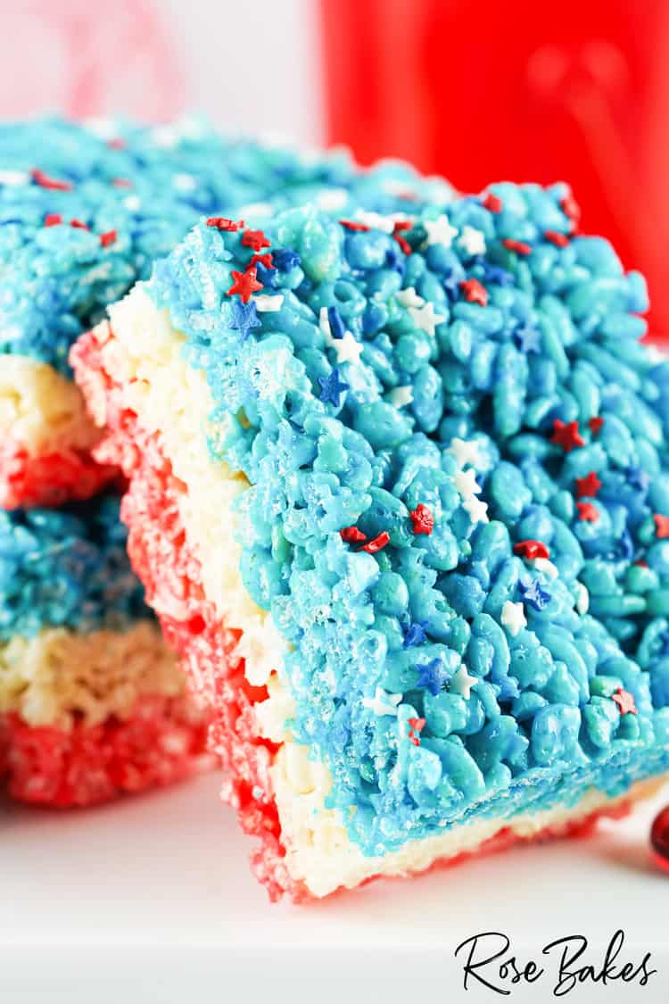 Red White and Blue Rice Krispie Treats squares stacked with one leaning at an angle